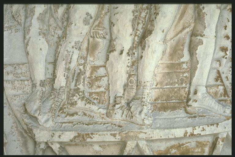 Legs of Romans crossing a bridge