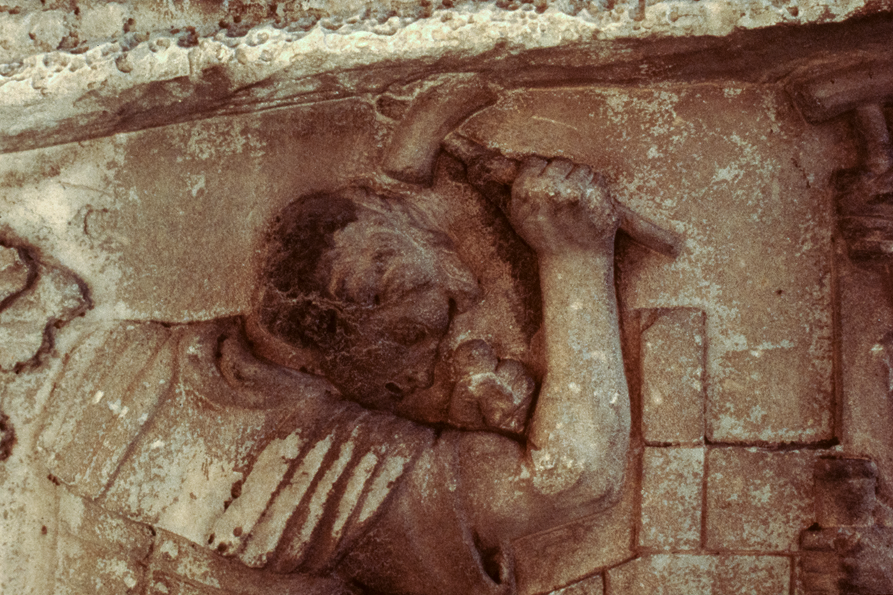 Legionary hammering a stake